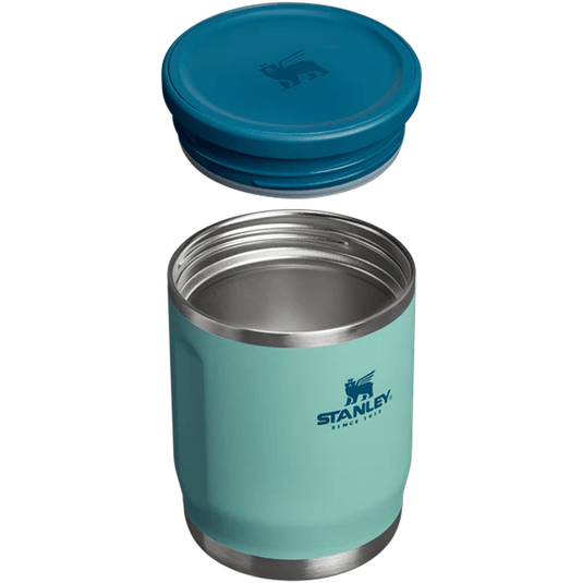 Teal Stanley insulated tumbler with blue lid on a white background