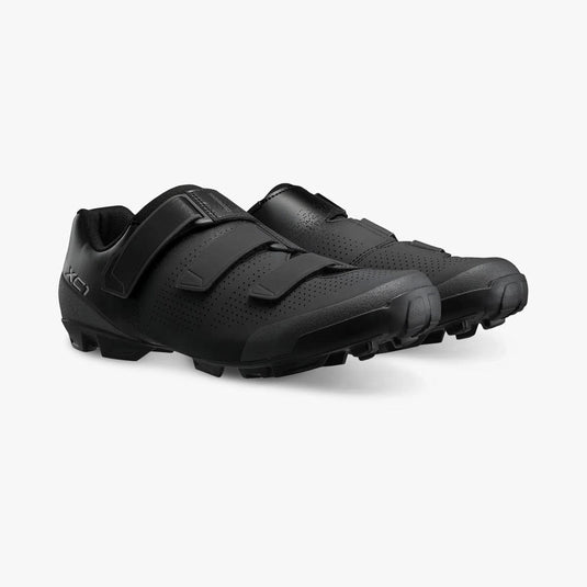 Pair of black cycling shoes on a white background