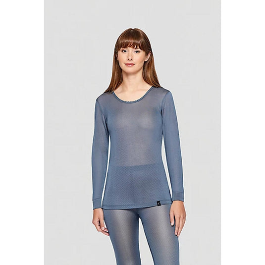 Woman wearing a blue long-sleeve top and leggings on a light gray background