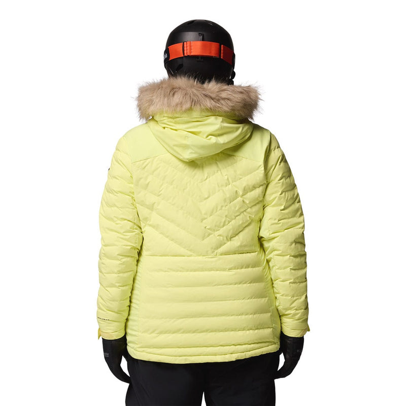 Load image into Gallery viewer, Person wearing a bright yellow puffer jacket with a fur-lined hood on a white background
