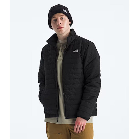 Person wearing a black jacket with a brand logo on a white background