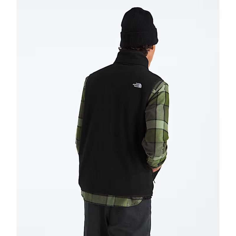 Load image into Gallery viewer, Person wearing a black fleece vest over a plaid shirt with The North Face logo.
