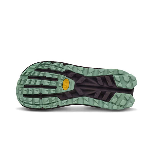 Close-up of a shoe sole with green and black pattern on a white background