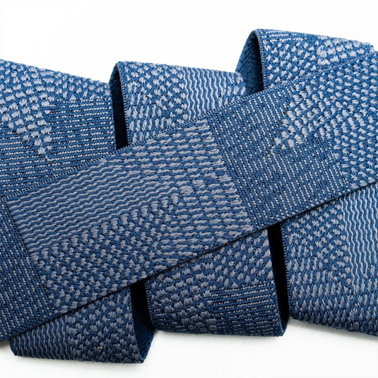 Close-up of a blue textured fabric roll on a white background