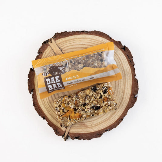 Dak Bar snack on a wooden log with a white background