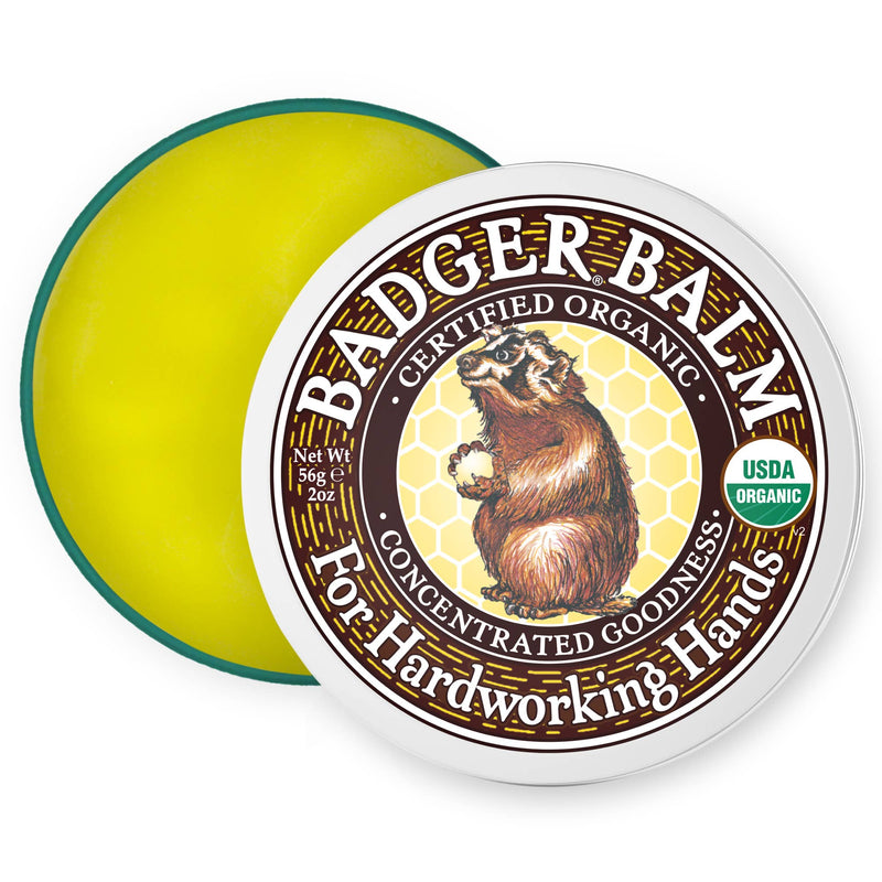 Load image into Gallery viewer, Badger Balm tin with yellow balm on a white background
