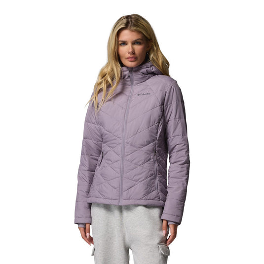 Woman wearing a purple quilted jacket on a white background