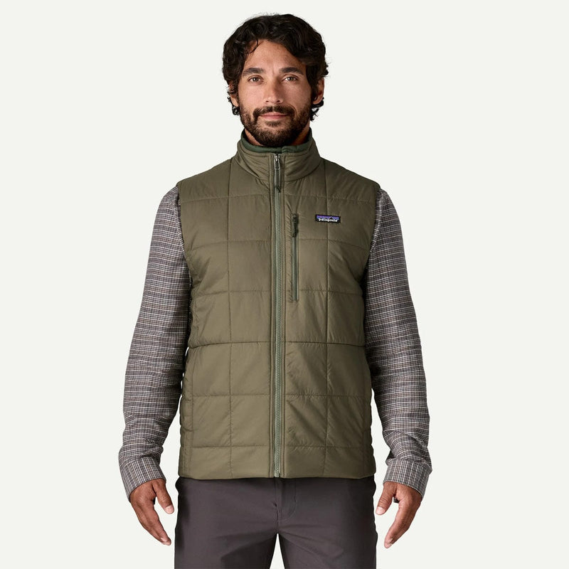 Load image into Gallery viewer, Man wearing a green puffer vest with a visible brand logo on a white background
