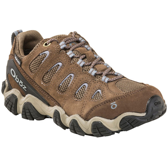 Brown hiking shoe with black sole on a white background