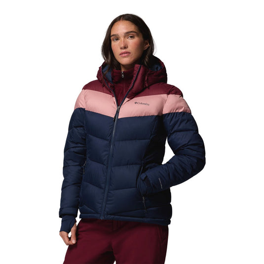 Woman wearing a multicolored puffer jacket on a white background