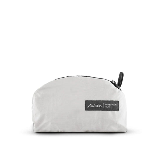 White pouch with a black zipper and label on a white background