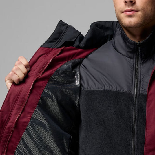 Person wearing a black and red jacket with a gray background