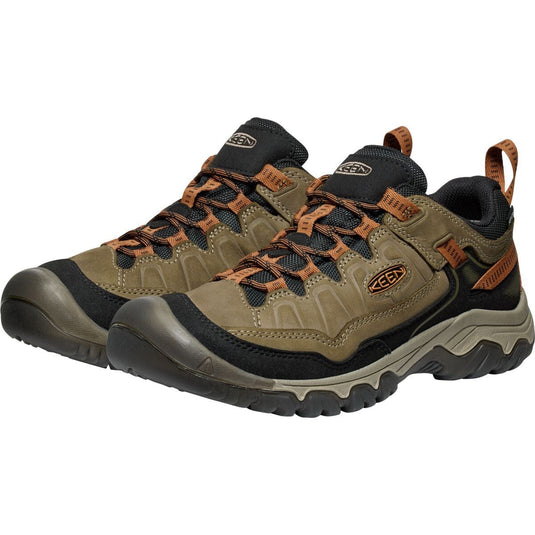 Pair of hiking shoes with brown and black design on a white background