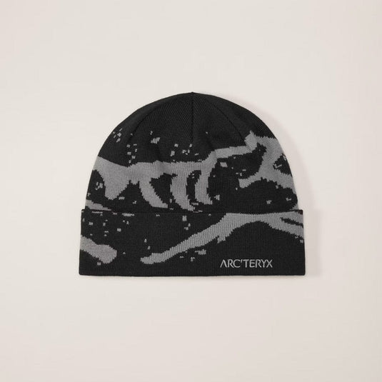 Black beanie with gray wolf design and Arc'teryx logo on a beige background