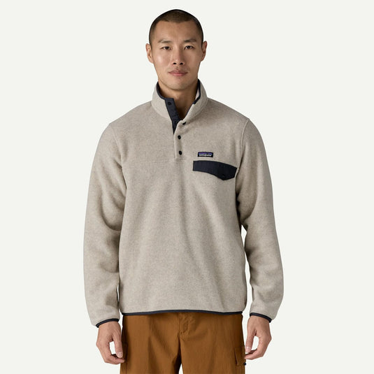 Man wearing a beige fleece pullover with a logo on a white background