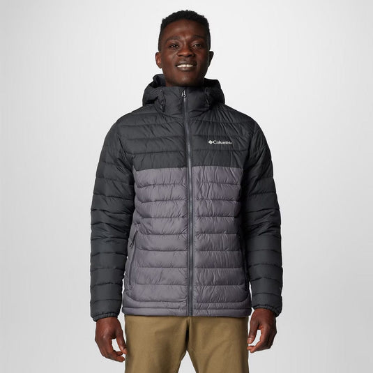 Man wearing a Columbia gray puffer jacket on a white background