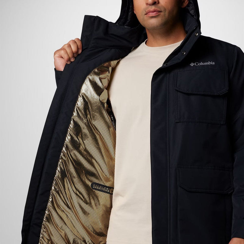 Load image into Gallery viewer, Person wearing a black Columbia jacket with a white shirt underneath, on a plain background
