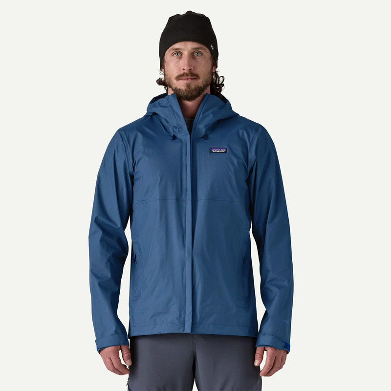 Load image into Gallery viewer, Man wearing a blue rain jacket with a visible brand logo on a white background
