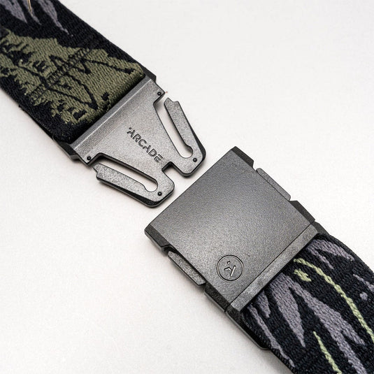 Two belts with camouflage patterns and metallic buckles on a white background