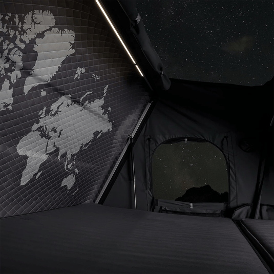 Tent interior with world map on wall and starry night view