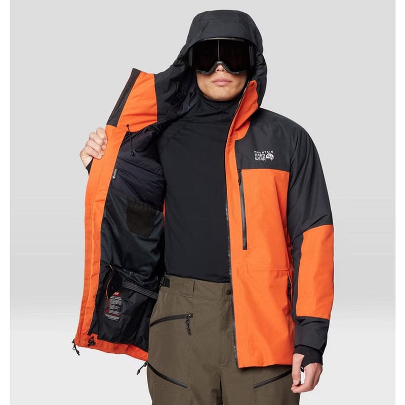 Load image into Gallery viewer, Person wearing an orange and black jacket with a visible brand logo on a gray background
