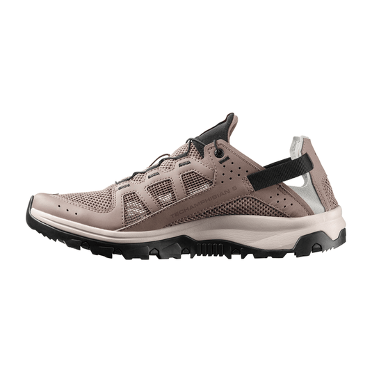 Brown hiking shoe with black sole on a white background