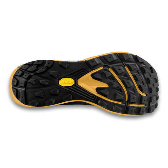 Close-up of a black and yellow sole with brand logo on a white background