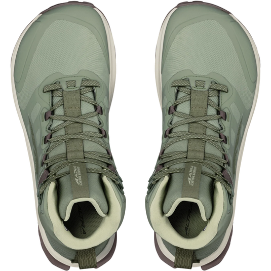 Pair of green hiking boots on a white background