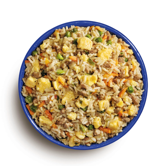 Bowl of fried rice with vegetables and meat on a white background