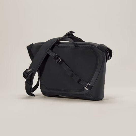 Black shoulder bag on a beige background