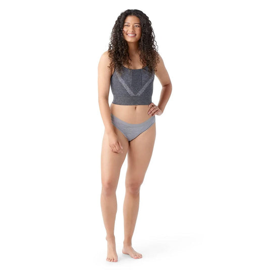 Woman wearing a gray bikini set on a white background