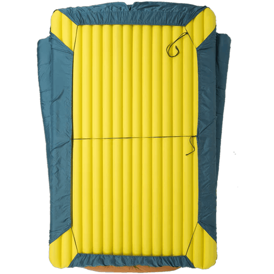 Yellow inflatable sleeping pad with blue exterior on a white background