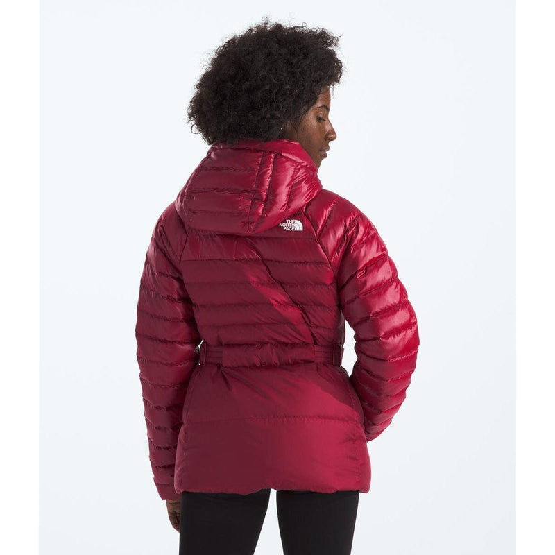 Load image into Gallery viewer, Person wearing a red puffer jacket with a brand logo on a white background
