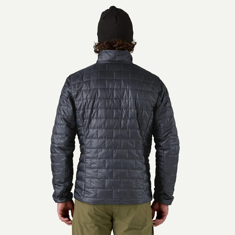 Load image into Gallery viewer, Person wearing a dark gray quilted jacket on a white background
