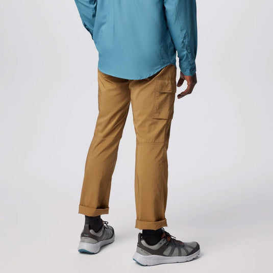 Person wearing a blue jacket, tan pants, and gray shoes on a white background
