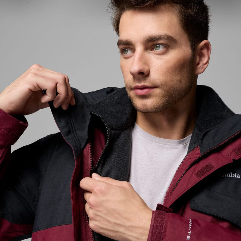 Load image into Gallery viewer, Man wearing a maroon and black jacket with Columbia logo on a gray background
