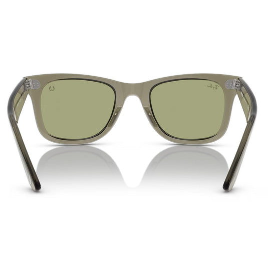 Sunglasses with green lenses and clear frame on a white background