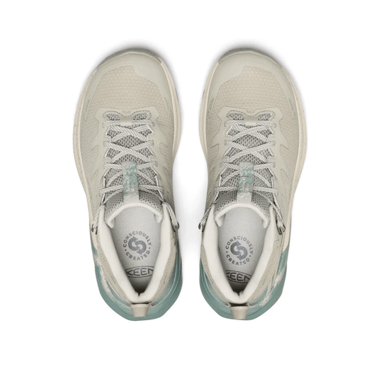 Pair of light gray sneakers with white soles on a white background