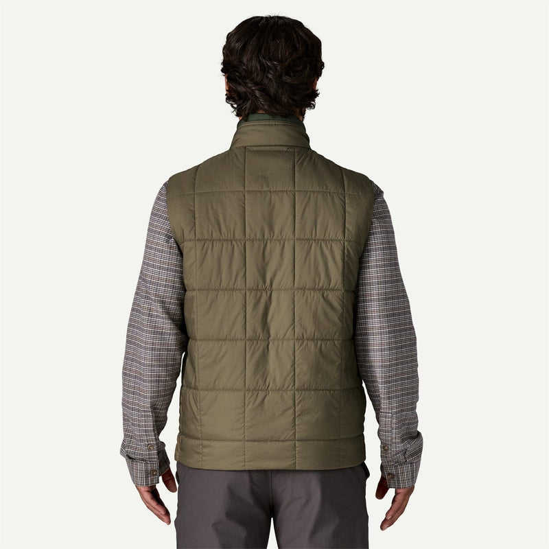 Load image into Gallery viewer, Person wearing a green puffer vest over a plaid shirt on a white background
