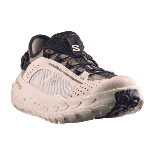 Beige and black athletic shoe on a white background