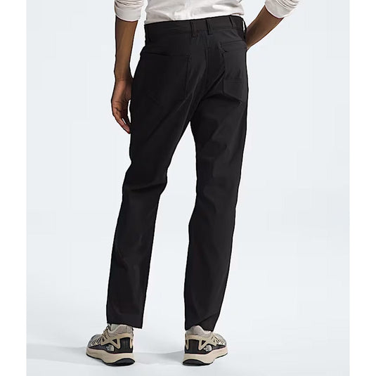 Person wearing black pants on a white background