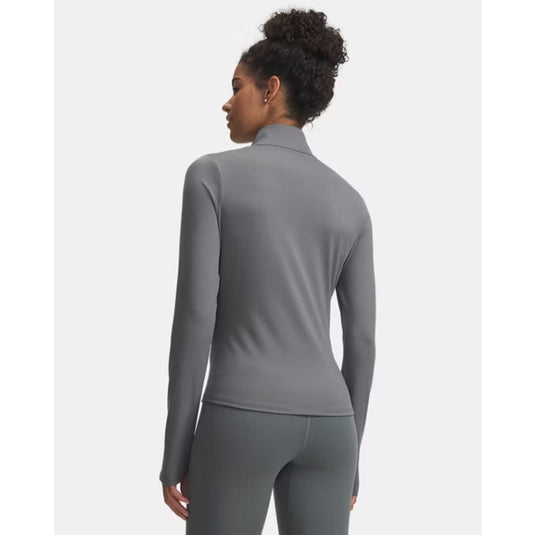 Person wearing a gray long-sleeve athletic top and leggings on a white background