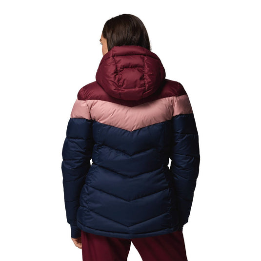 Person wearing a two-tone puffer jacket with maroon and navy colors on a white background