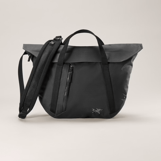 Black backpack with a visible brand logo on a light gray background
