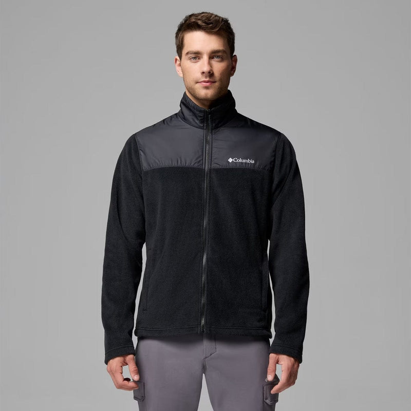 Load image into Gallery viewer, Man wearing a black Columbia jacket on a gray background
