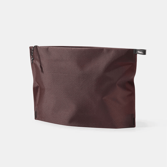 Brown textured pouch with a brand label on a white background