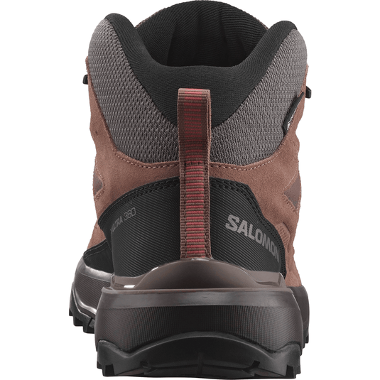 Brown hiking boot with black sole on a white background
