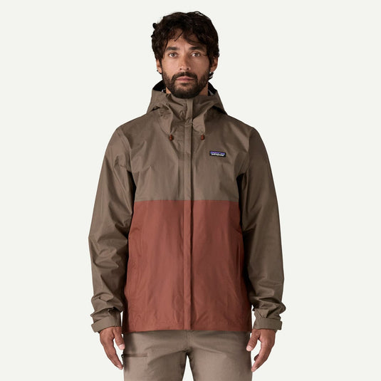 Man wearing a two-tone rain jacket with a visible brand logo on a white background