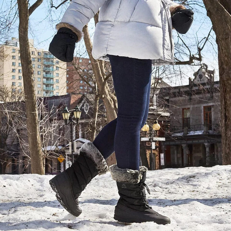 Woman wearing Kamik Momentum 3 winter boots designed for snow and ice, styled with winter outerwear outdoors.