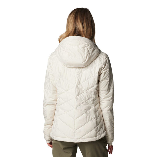 Person wearing a white quilted jacket on a white background